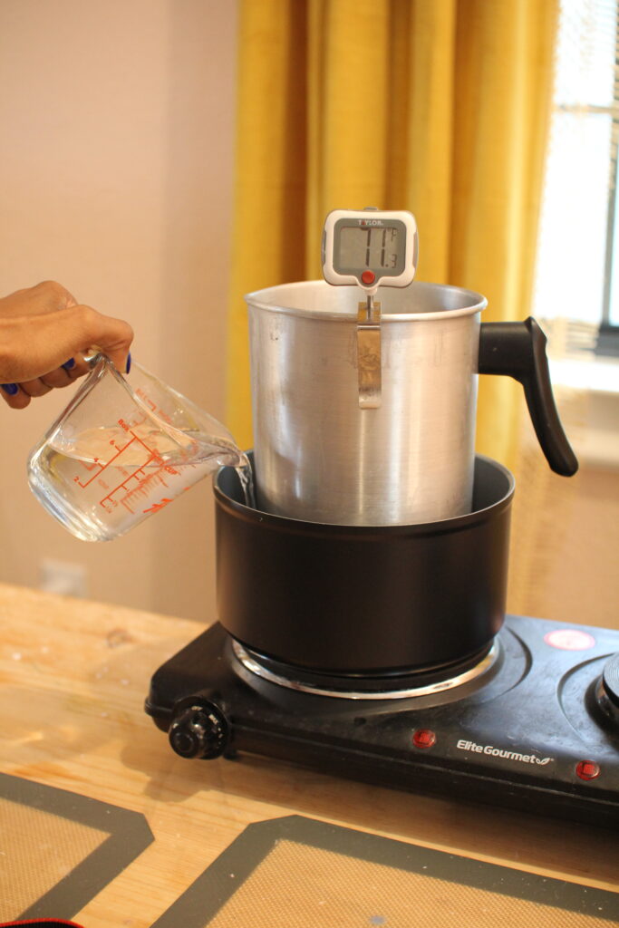 pouring-water-into-double-boiler-setup