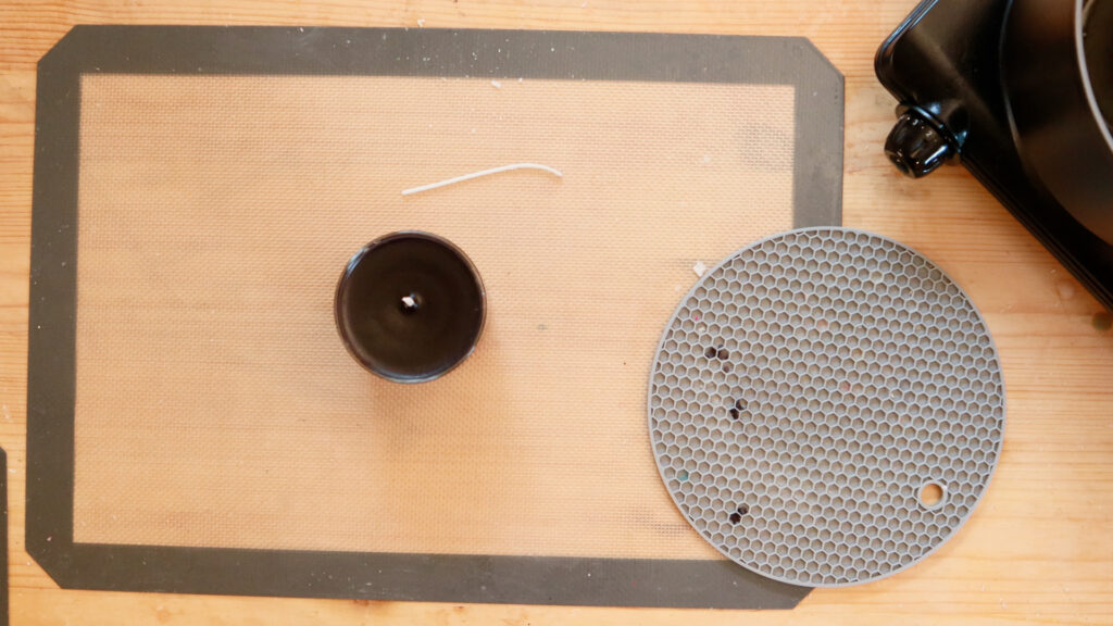 black-candle-on-wooden-table