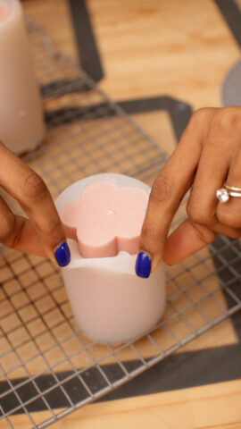 removing-pink-flower-shaped-candle-from-silicone-candle-mold