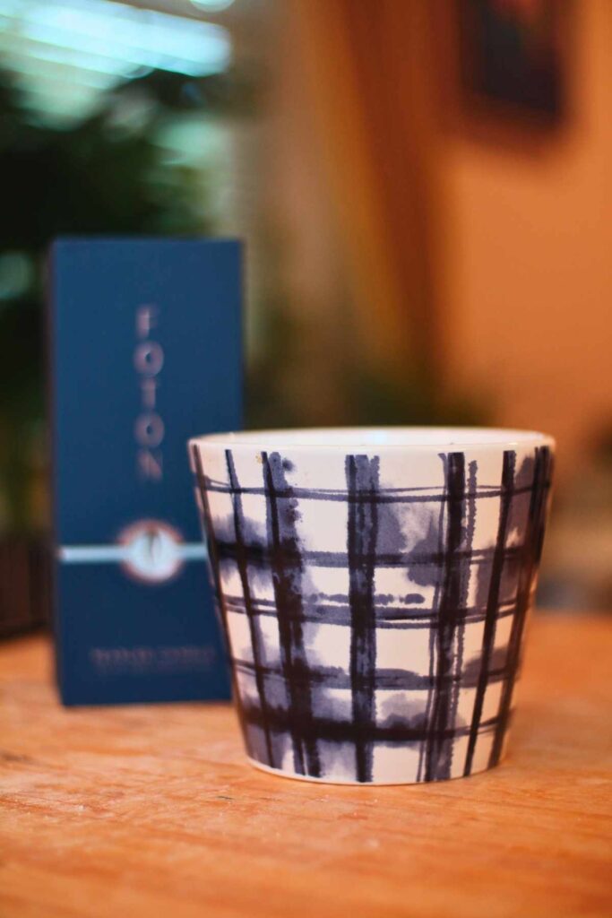 blue and white ceramic container on a wooden table